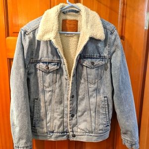 A fleece lined Levis denim trucker jacket with pockets, snap front.